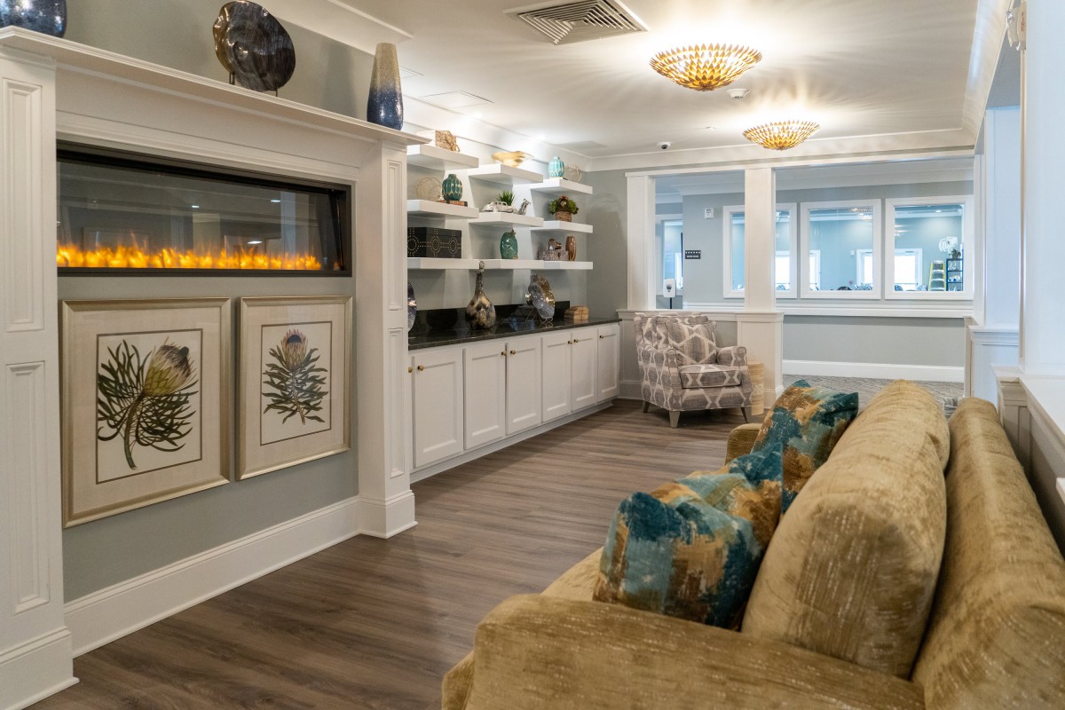 A cozy living room with a modern fireplace and stylish decor.