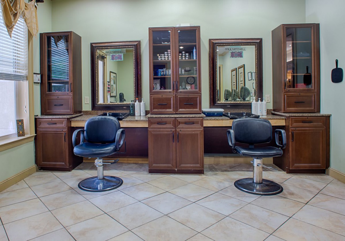 Interior of a modern hair salon with styling chairs and mirrors.