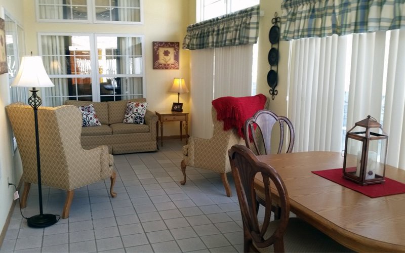 A cozy living and dining area featuring a sofa, dining table with chairs, and tasteful decor.