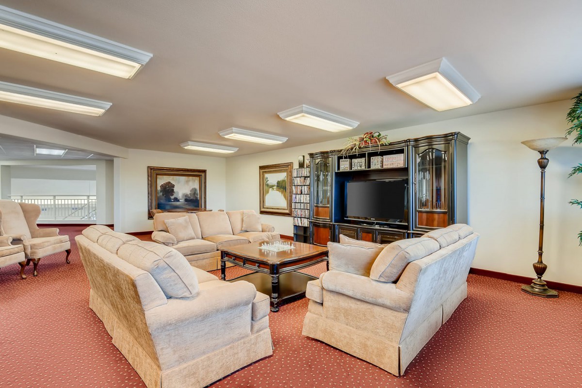 Spacious living room with comfortable sofas and a large television.