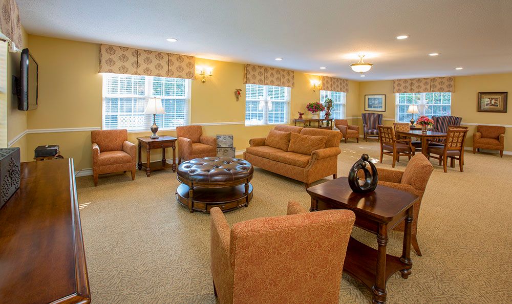 A well-furnished living room with sofas and tables arranged for comfort.