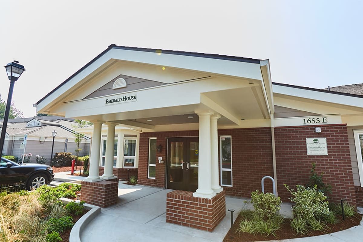 A well-maintained building entrance featuring classical columns and brickwork.