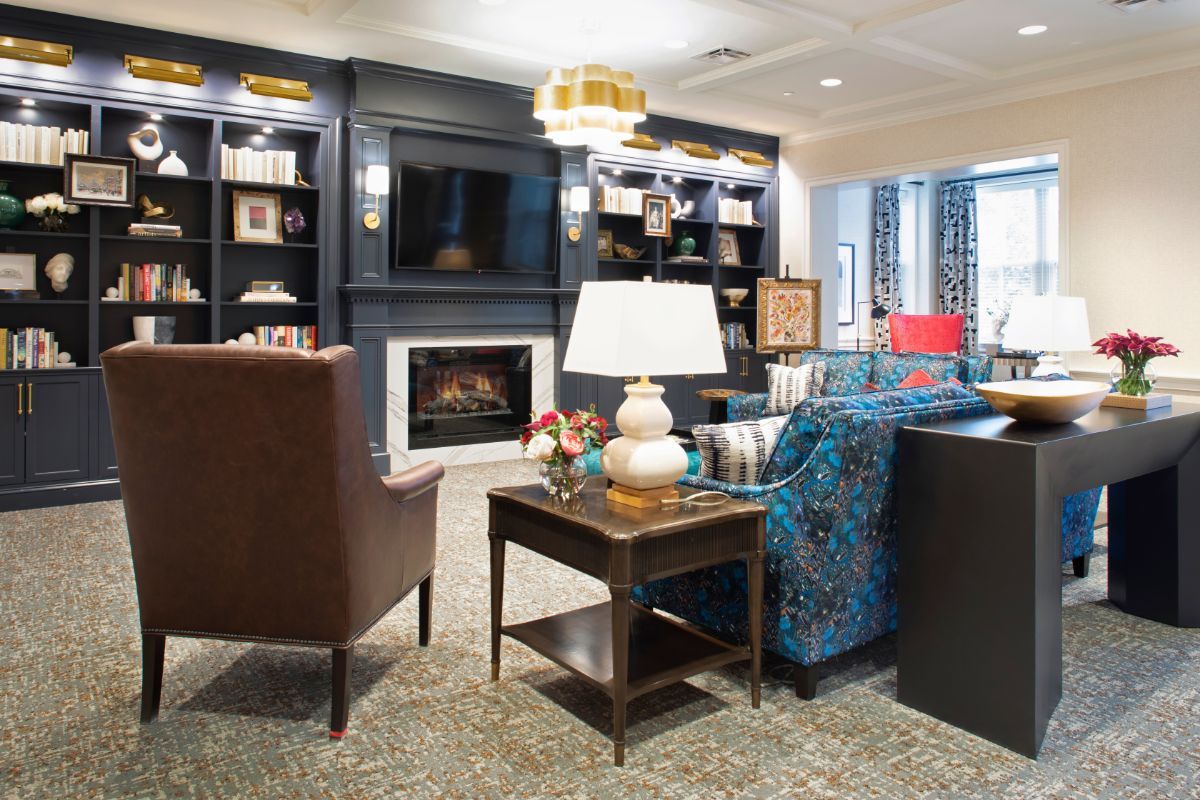 A cozy living room interior featuring a fireplace, comfortable seating, and elegant decor.