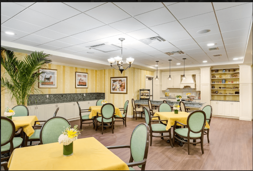 A cozy dining area with yellow tablecloths and elegant decor.
