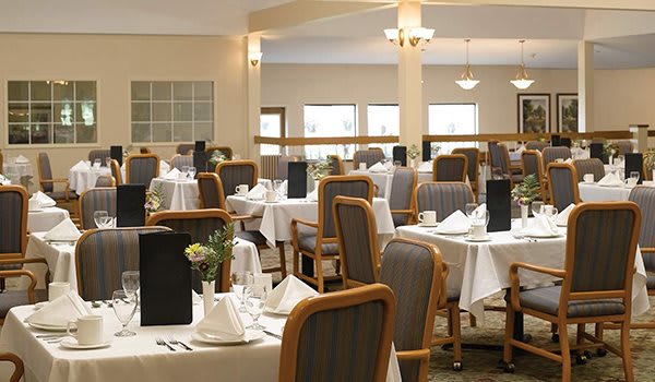 An elegant restaurant interior with neatly arranged tables and chairs.