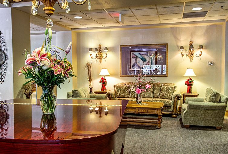 A well-decorated lobby with comfortable seating and elegant floral arrangements.