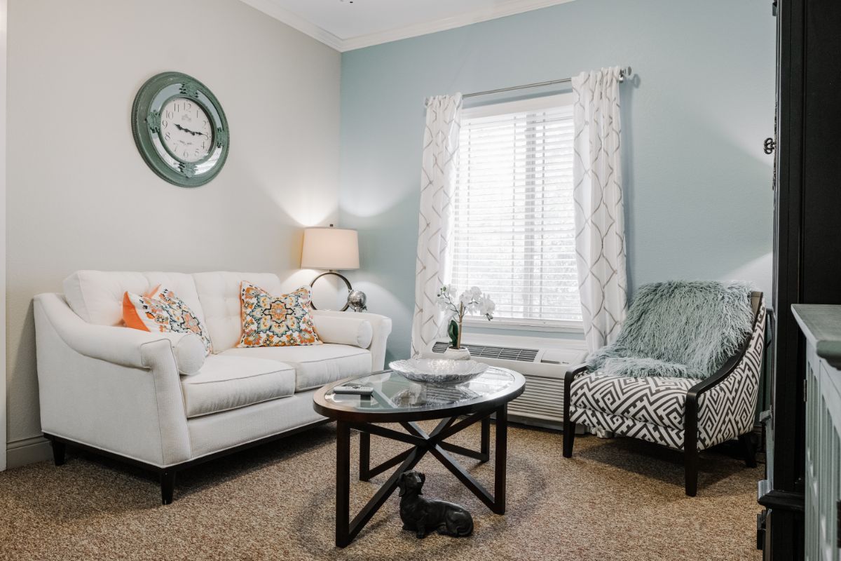 A cozy living room with a sofa, coffee table, and decorative elements.
