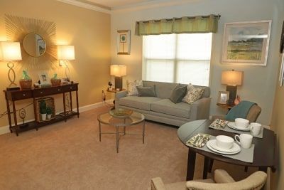 Cozy living room with a sofa, coffee table, and dining area.