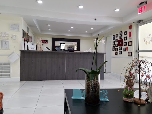 A modern reception area featuring a sleek desk and decorative plants.