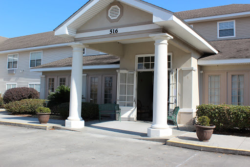 A welcoming entrance featuring classic columns and a spacious porch.