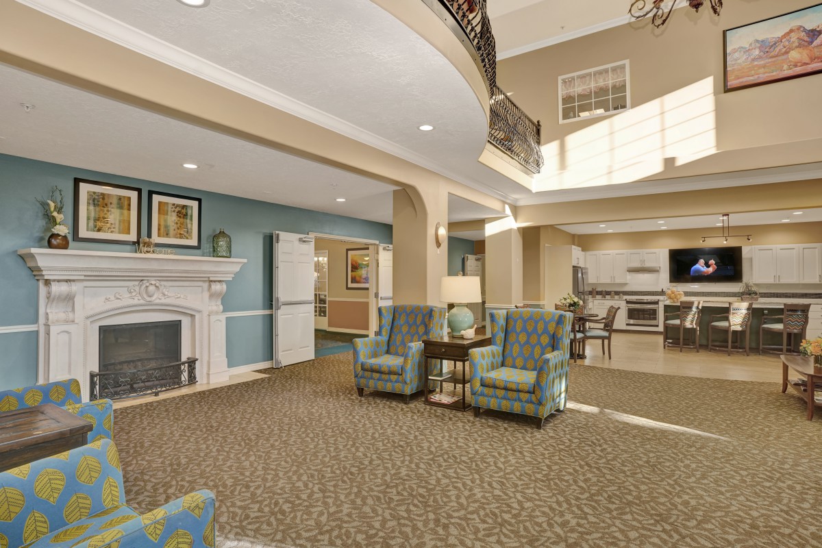 A modern lobby with comfortable seating and a fireplace.