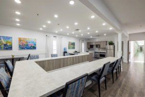 A modern kitchen and dining area with ample seating and bright lighting.