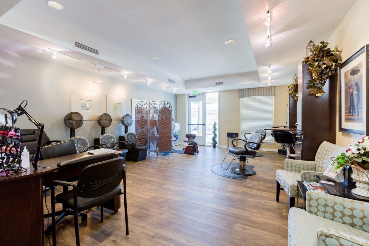 A spacious salon interior with modern chairs and hair styling stations.