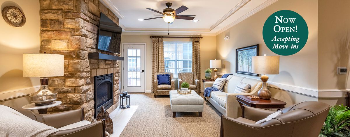 A cozy living room featuring a fireplace, comfortable seating, and elegant decor.