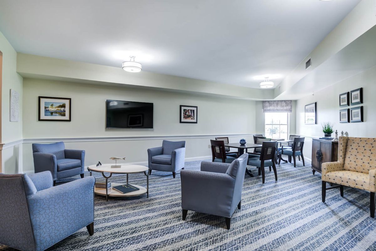 A modern living room with comfortable seating and a large television.