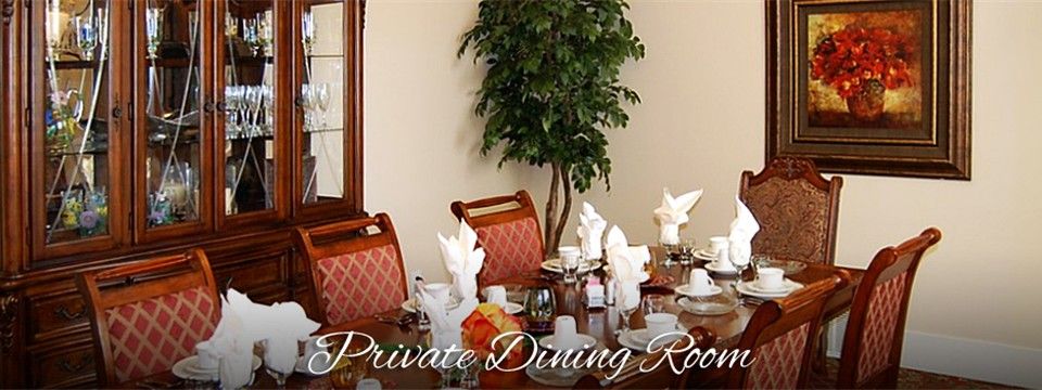 A well-set private dining room with elegant table settings and decor.