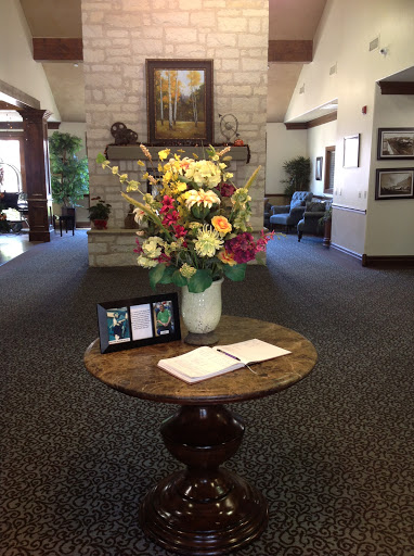 A welcoming lobby space featuring a beautiful floral arrangement and a table for notes.