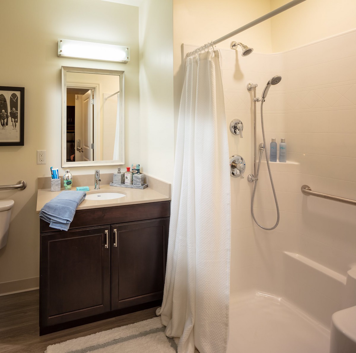 A clean, well-lit bathroom with a shower and vanity area.