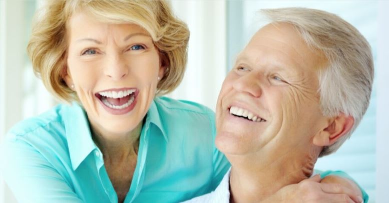 A joyful senior couple sharing a moment of laughter.
