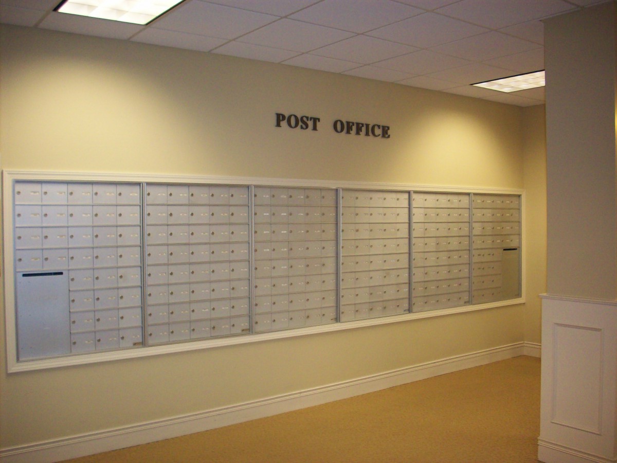 Interior view of a post office with wall-mounted mailboxes.