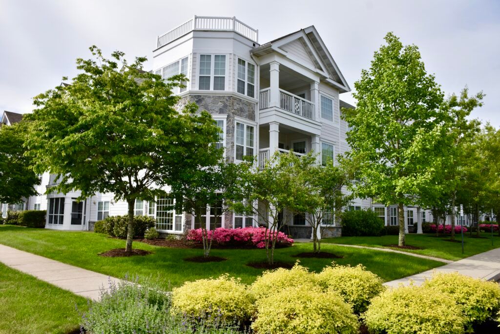 A well-maintained apartment building with lush landscaping and balconies.