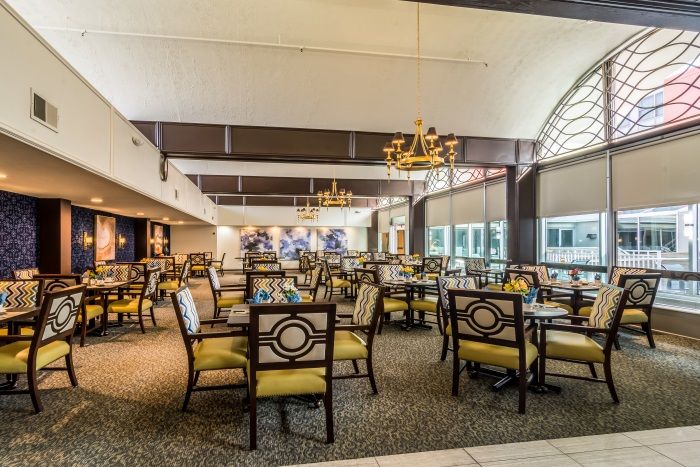 A spacious dining area with elegant furniture and bright lighting.