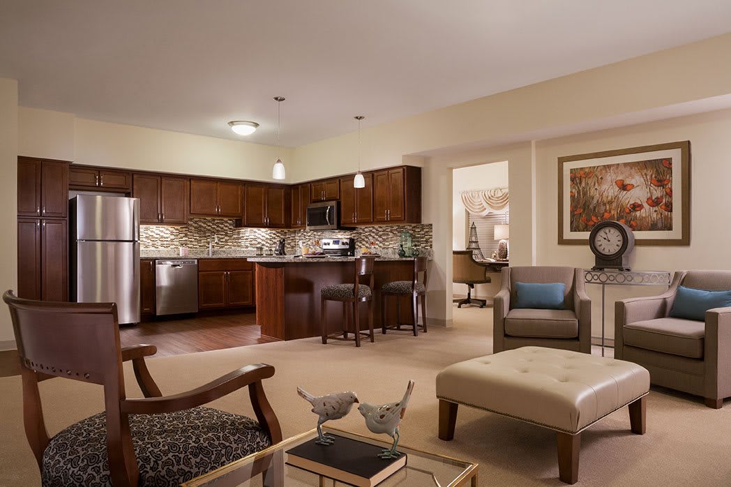 A modern open-concept living area with a cozy seating arrangement and adjacent kitchen.