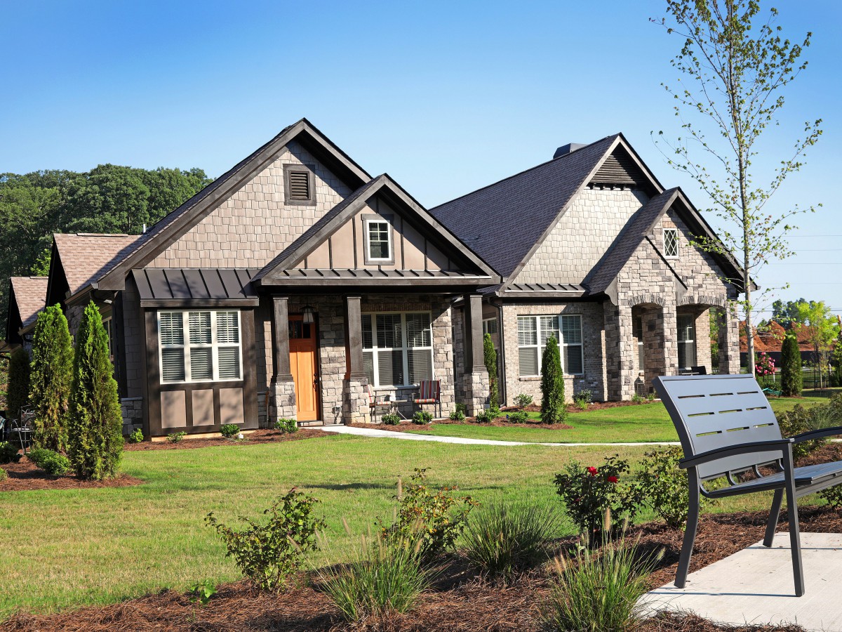 A picturesque residential house with a well-maintained garden and lawn.