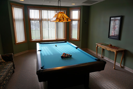 A well-lit game room featuring a blue pool table, perfect for recreational activities.