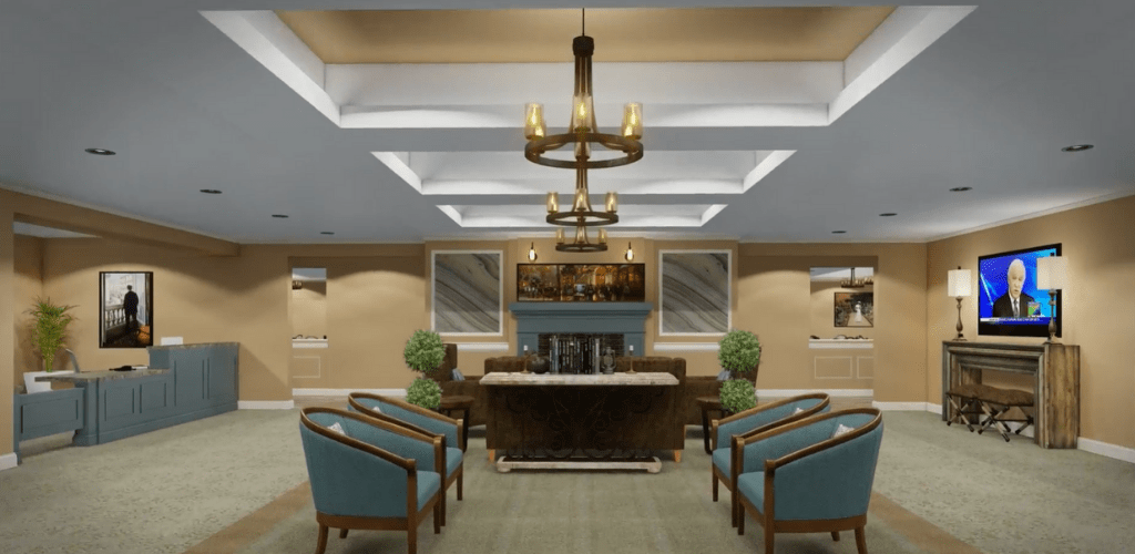 A modern lobby with stylish seating and a central chandelier.