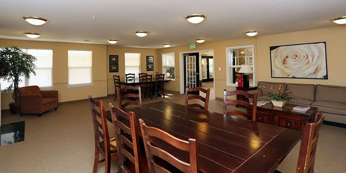 Spacious dining room with a large wooden table and multiple chairs.