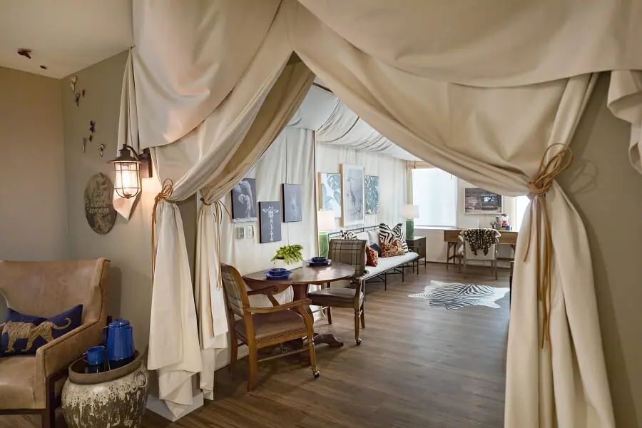A cozy interior with tent-like draping, comfortable seating, and decorative elements.