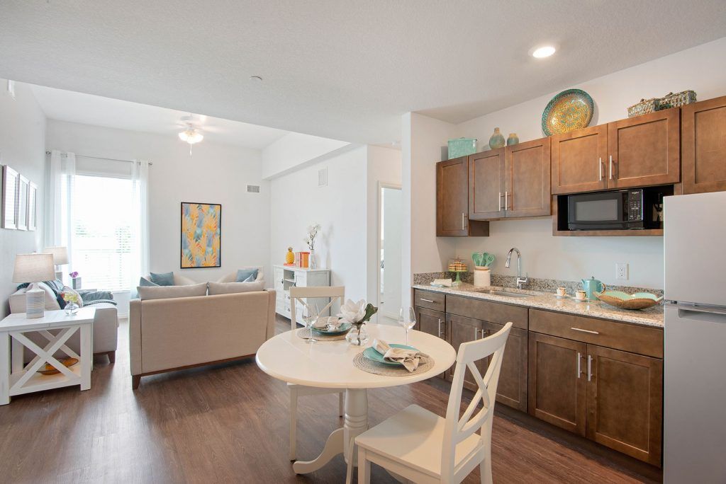 Modern open-concept kitchen and living area with wood flooring and stylish decor.