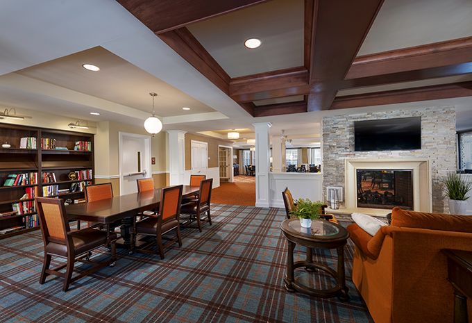 A cozy interior space with a lounge area, conference table, and fireplace.
