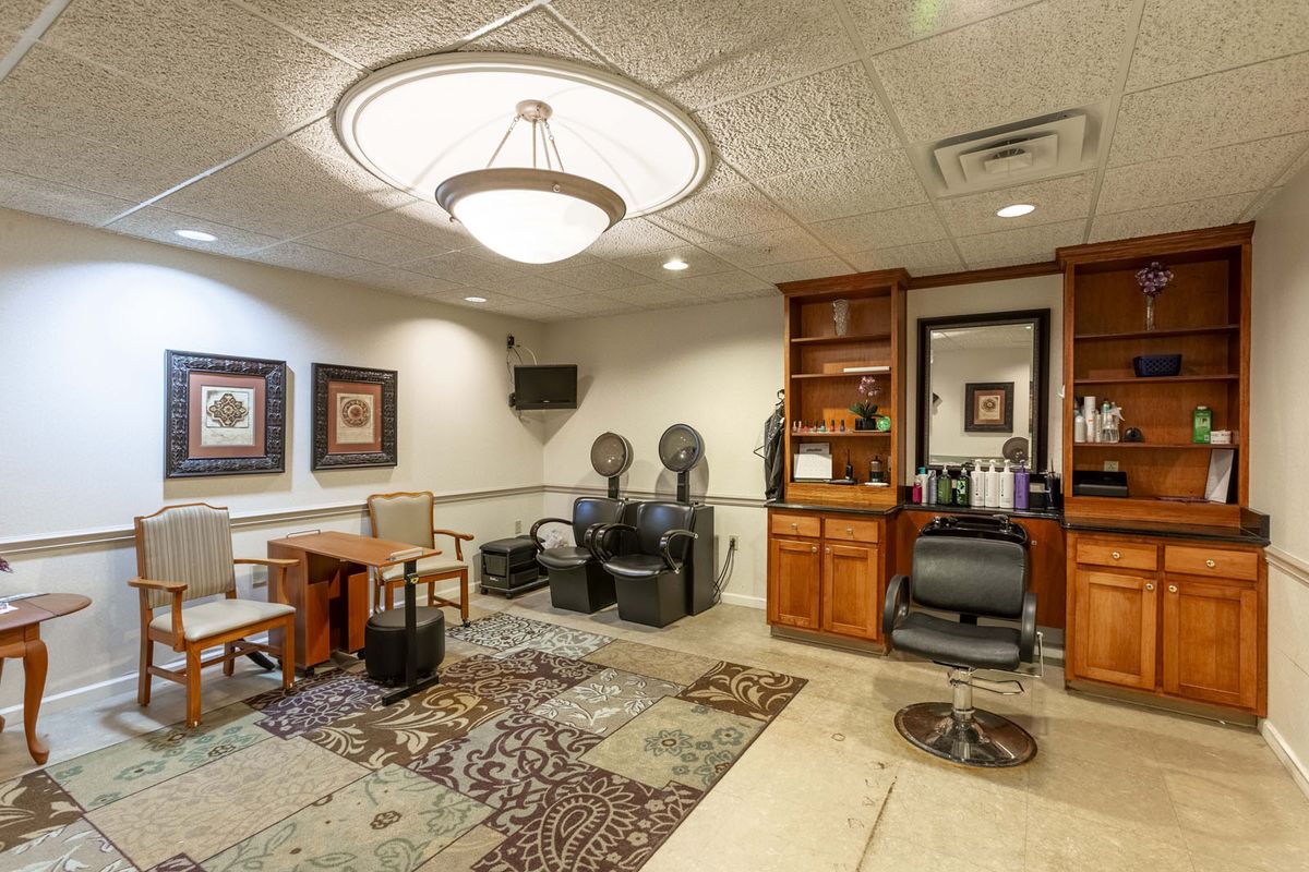 A well-furnished salon interior with chairs, mirrors, and stylish decor.