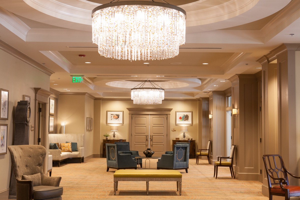 A luxurious hotel lobby with elegant chandeliers and comfortable seating.