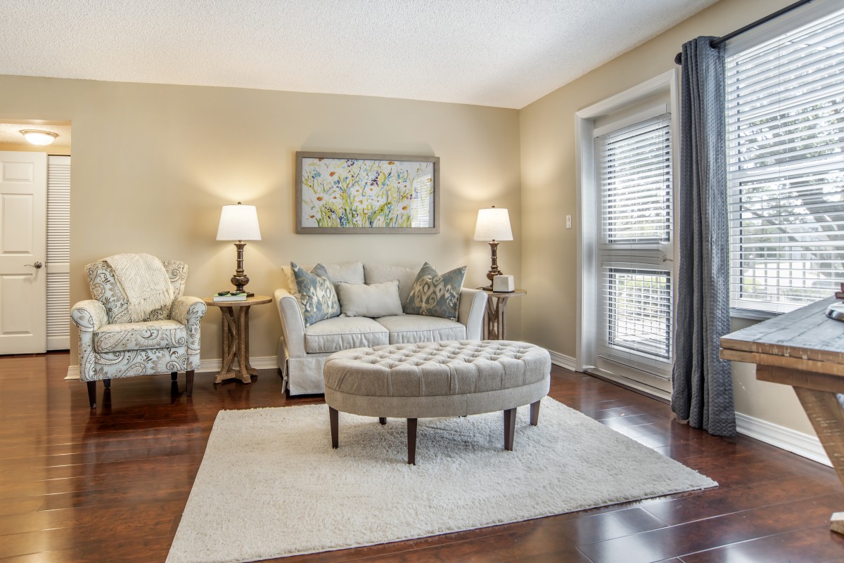 A cozy living room with a sofa, armchair, coffee table, and decorative accents.