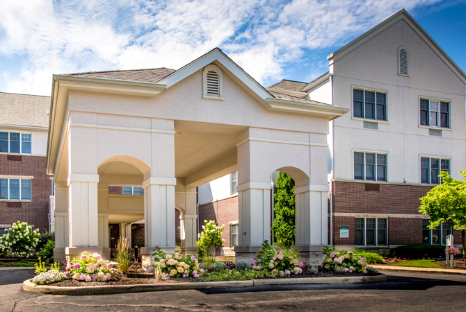 A modern hotel building with a welcoming entrance and well-maintained landscaping.