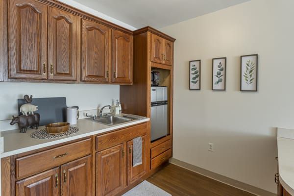 A cozy kitchen space with wooden cabinets and modern appliances.