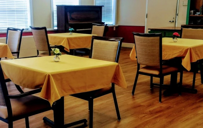 A cozy dining area with tables and chairs neatly arranged.