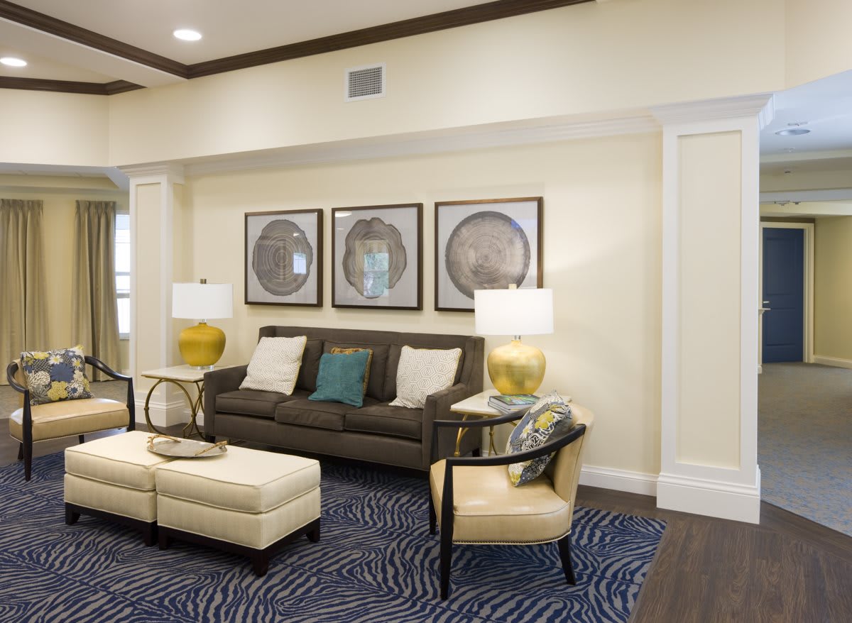A modern living room featuring a comfortable sofa, elegant lamps, and stylish artwork.