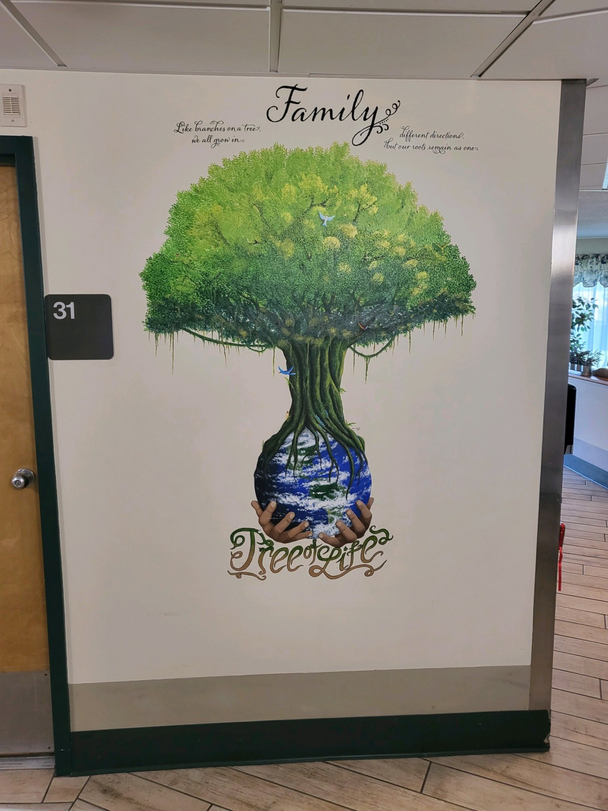 A vibrant mural featuring a tree with a 'Family' theme on a wall.