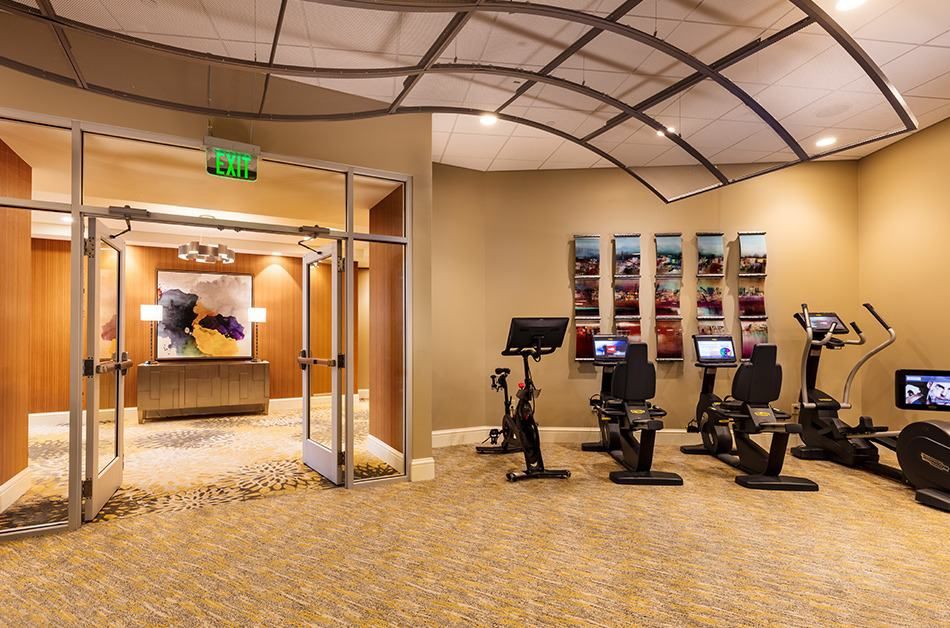 A modern gym with exercise bikes and sleek interior design.