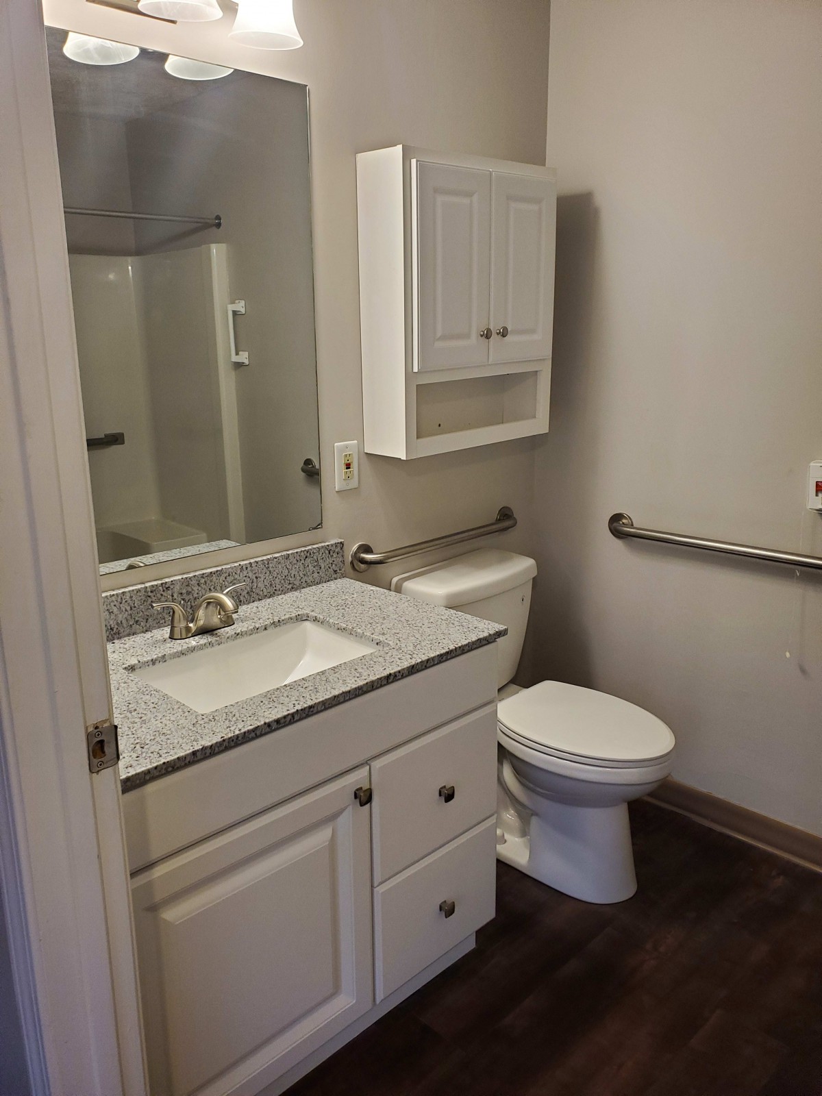 A modern bathroom with a sink, toilet, and shower.