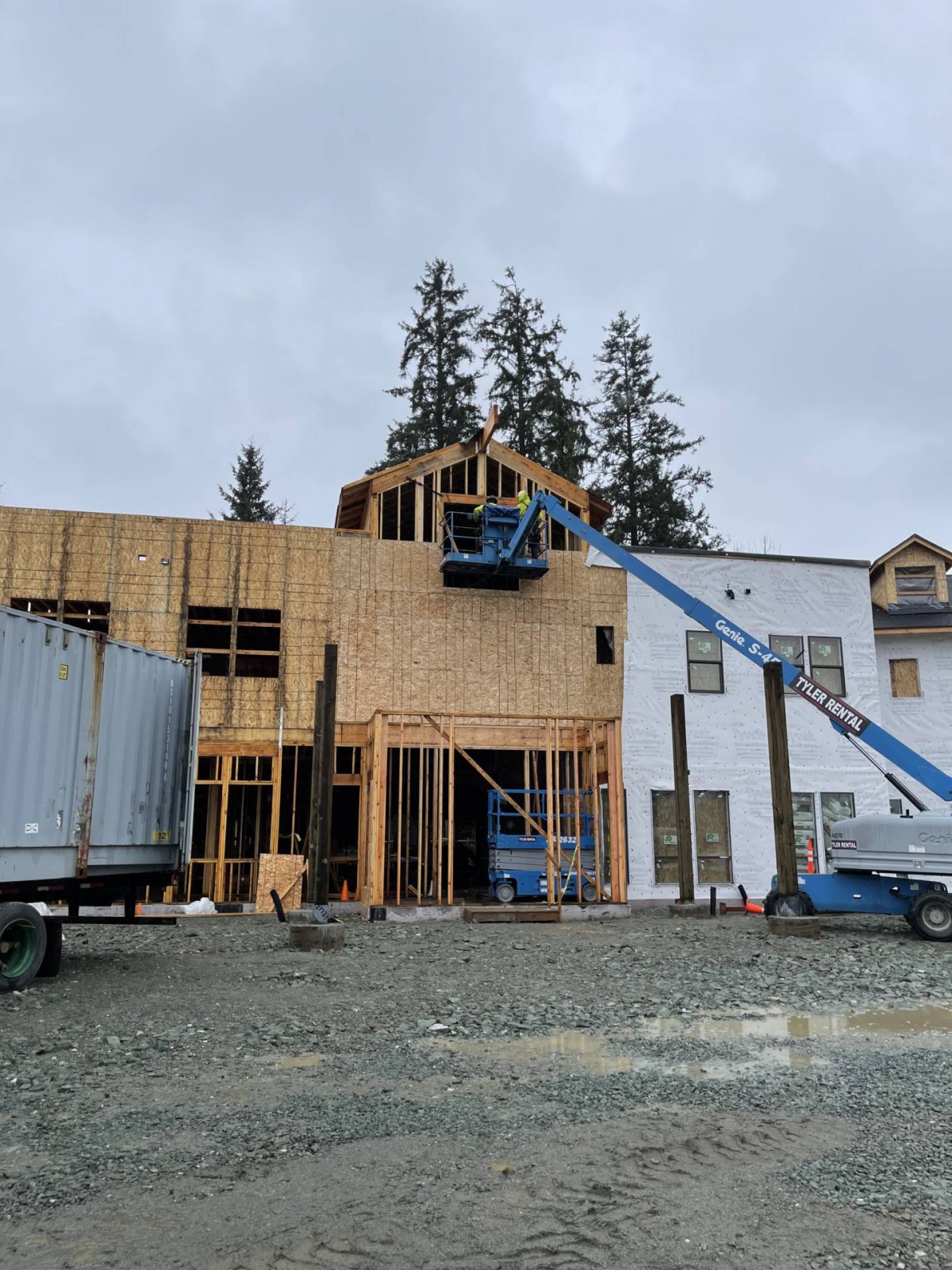 A construction site with a wooden framework and machinery.