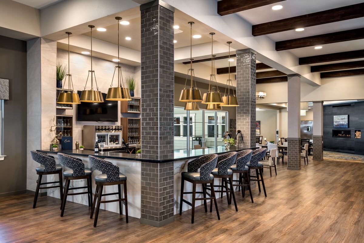 A modern restaurant interior with a stylish bar area and contemporary lighting.