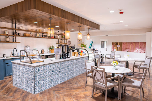 A stylish and modern kitchen space designed for dining, featuring elegant lighting and comfortable seating.