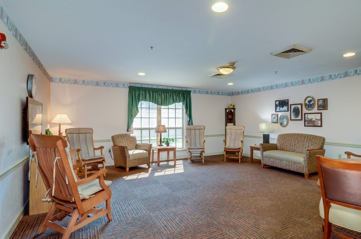 A cozy living room with rocking chairs, a sofa, and decorative elements.