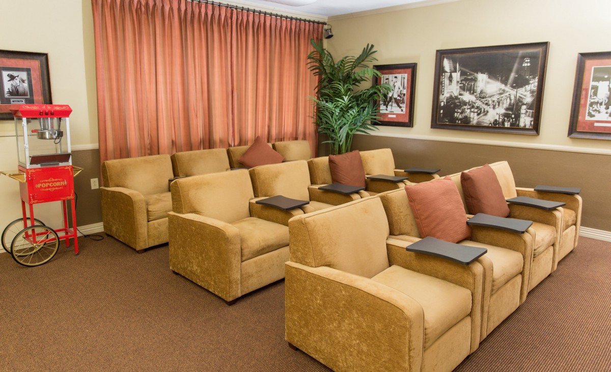 A cozy lounge area with rows of comfortable armchairs and decorative pillows, designed for meetings or relaxation.