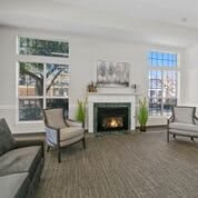 A cozy living room with a fireplace and elegant seating arrangement.